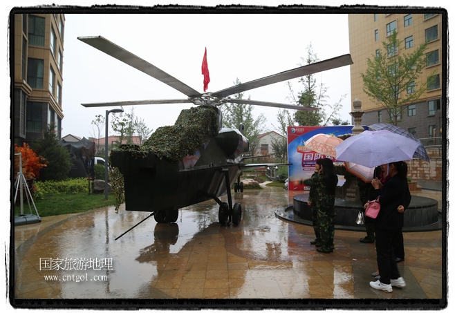 小區(qū)突然出現(xiàn)“飛機(jī)坦克”，其中殲15艦載戰(zhàn)斗機(jī)一架、99式主戰(zhàn)坦克一輛、武直-10武裝直升機(jī)一架，吸引了眾多市民雨中圍觀、合影。